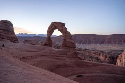 A stunning view of Delicate Arch during sunrise on a cool October morning. Stock Photos