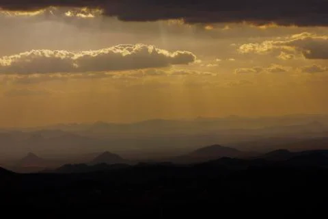 Stunning view of distant mountains, beneath golden hour sky Stock Photos
