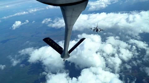 Stunning View of a Fighter Jet During Aerial Refueling Over the Clouds Stock Footage 130362228
