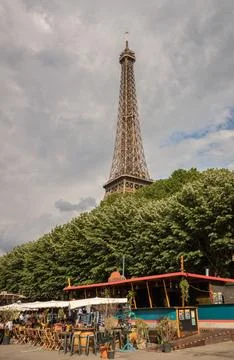 Stunning view of the iconic Eiffel Tower in Paris, France, with a quaint cafe in Stock Photos