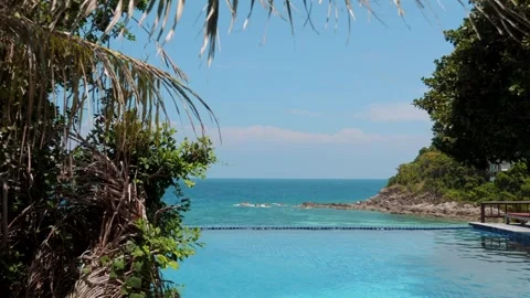 Stunning view from infinity swimming pool overlooking the turquoise sea. Stock Footage 245943420