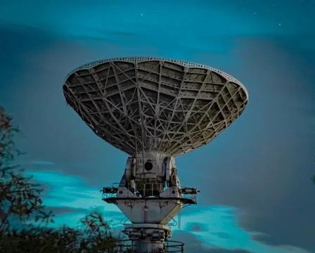 Stunning view of a large array radio telescope against a green sky background 스톡 사진