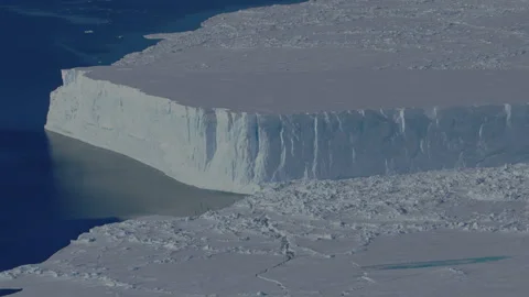 Stunning view of massive Antarctic sea ice cliff and included icebergs in polar Stock Footage 288229837