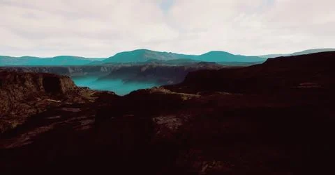 Stunning view of mountain landscape with mist and dramatic terrain at dusk Illustrazione stock