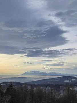 A stunning view of mountains under a dramatic sky at twilight, showcasing the Stock Photos