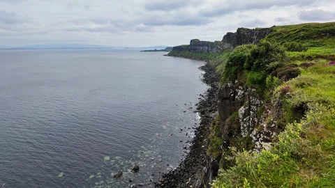 Stunning view of a rocky cliff and calm sea at the coastline of Isle of Skye Stock Footage 342184890