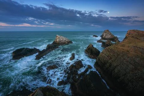 Stunning view of the sea cliffs by moonlight on the northern Scottish coast and Stock Photos