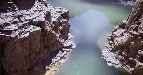 Stunning view of a serene river cutting through rocky canyon landscape Stock Illustration