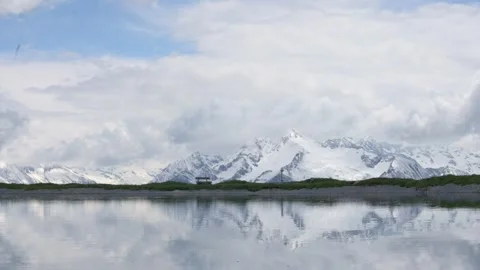 A stunning view of snow-capped peaks reflecting in a calm alpine lake on Penken Stockbeeldmateriaal 283374477