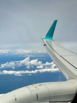 A stunning view through an airplane window, showcasing clear skies and fluf.. Stock Photos