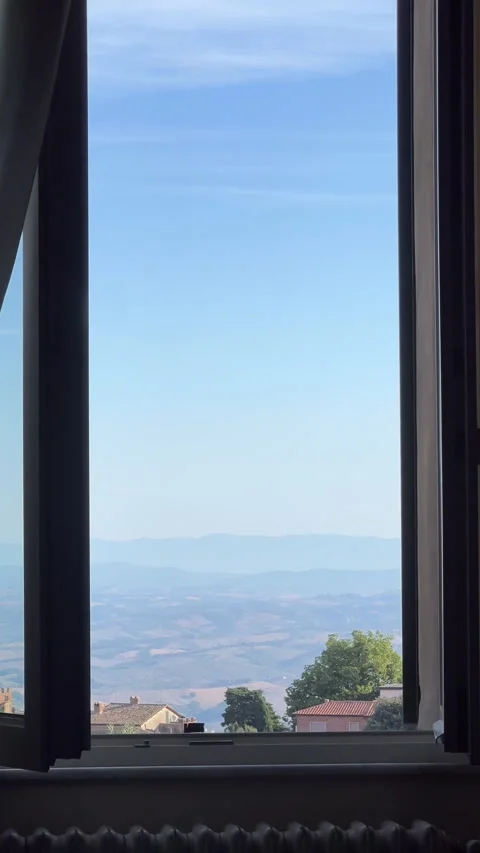A stunning view through the window shows rolling hills under a vast blue sky Stock-Footage 306082104