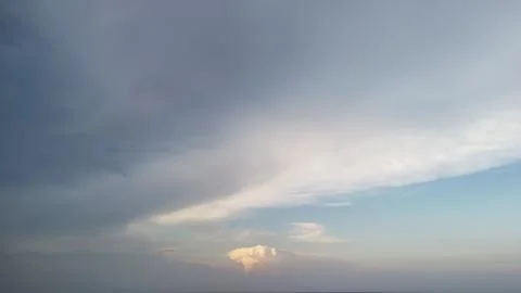 A stunning view of a vast sky showcasing layered clouds, transitioning from gray 写真素材