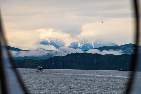 Stunning view from the window of the boat on the volcano and the sea, seascape. Stock Photos