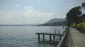 Stunning view of wooden pier on lake Garda and Monte Baldo mountains, landscape 4k or 4k+ Resolution