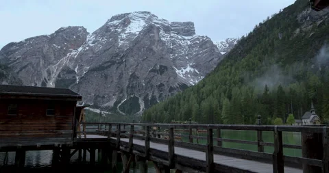Stunning views of alpine mountain landscape and tranquil lake at dawn in Italy Video stock 314082661