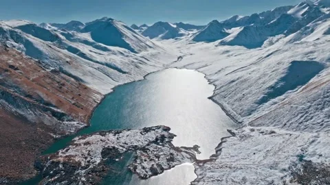 Stunning views of a remote glacier lake in snowy mountains Stock Footage 320303971
