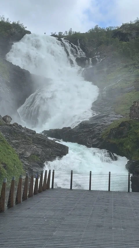 A stunning waterfall cascades down rocky cliffs Stock Footage 313948656