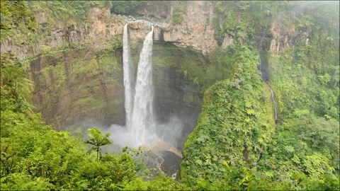 A stunning waterfall falls into a ravine Stock Footage 294977357