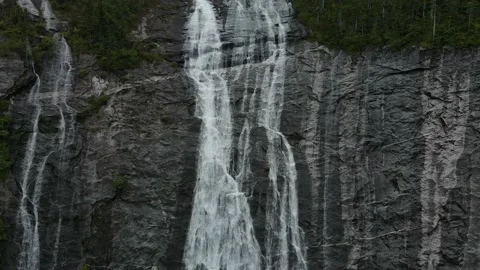 Stunning Waterfall flowing down the cliff side, Aerial View Stock Footage 169554604