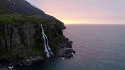 Stunning waterfalls cascade down cliffs at sunset Video stock 320262858