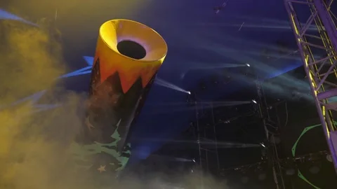 A stunt cannon in a circus in the arena under the light of spotlights and smoke. Stock Footage 309987141