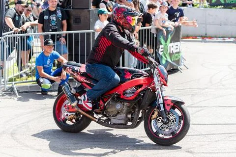 Stunt driver do acrobatics and stunts with his motorbike Stock Photos