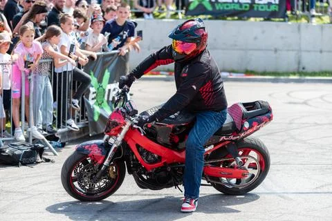 Stunt driver do acrobatics and stunts with his motorbike Stock Photos
