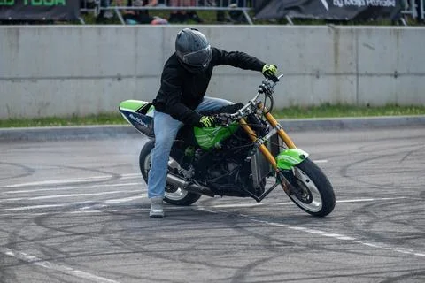 Stunt driver do acrobatics with their motorbike Stock Photos