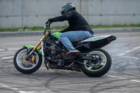 Stunt driver do acrobatics with their motorbike Stock Photos