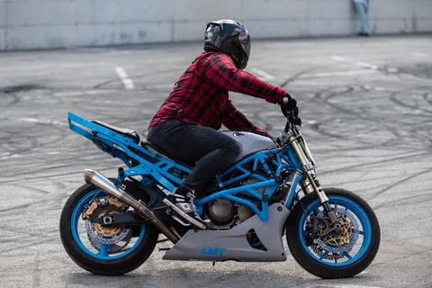 Stunt driver do acrobatics with their motorbike Stock Photos