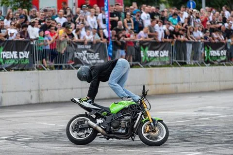 Stunt driver doing acrobatics and stunts with his motorbike Stock Photos