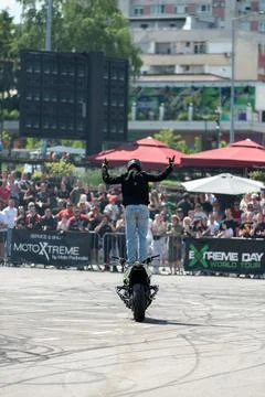 Stunt driver doing acrobatics and stunts with his motorbike Stock Photos