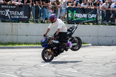Stunt driver doing his acrobatics and stunts with his motorbike Stock Photos
