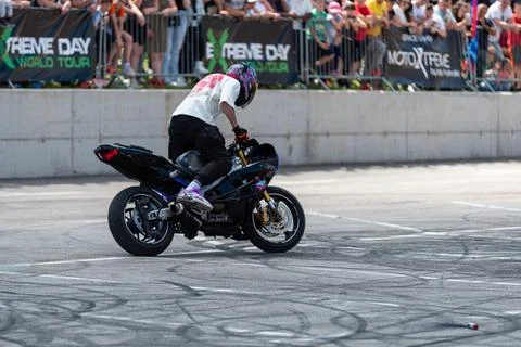 Stunt driver doing his acrobatics and stunts with his motorbike Stock Photos