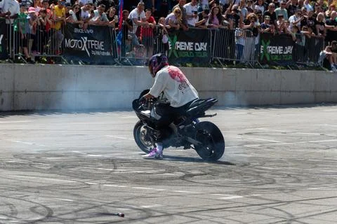 Stunt driver doing his acrobatics and stunts with his motorbike Stock Photos