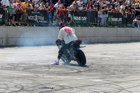 Stunt driver doing his acrobatics and stunts with his motorbike Stock Photos