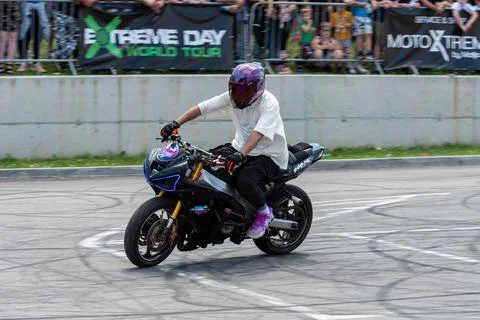 Stunt driver doing his acrobatics and stunts with his motorbike Stock Photos