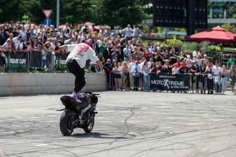Stunt driver doing his acrobatics and stunts with his motorbike Stock Photos