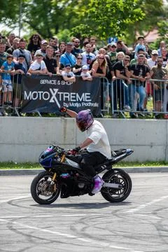 Stunt driver doing his acrobatics and stunts with his motorbike Stock Photos