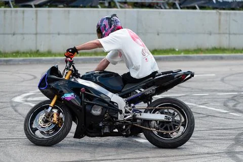 Stunt driver doing his acrobatics and stunts with his motorbike Stock Photos