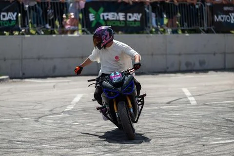 Stunt driver doing his acrobatics and stunts with his motorbike Stock Photos
