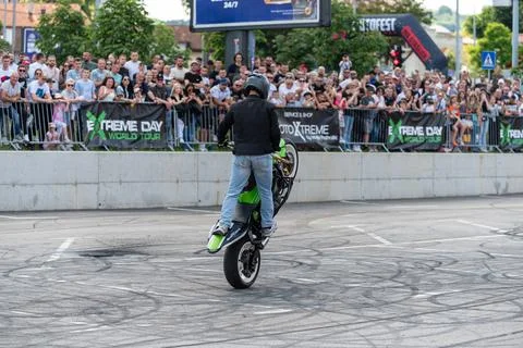 Stunt driver doing wheelie stunts with his motorbike Stock Photos