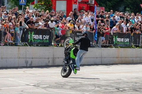 Stunt driver doing wheelie stunts with his motorbike Stock Photos