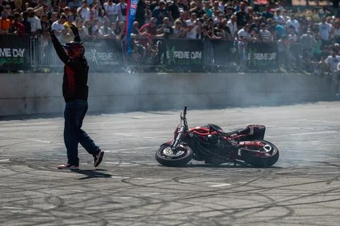 Stunt driver greets audience after his performance Stock Photos
