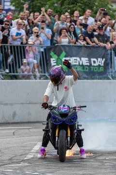 Stunt driver perform burnout in fire with his motorbike Stock Photos