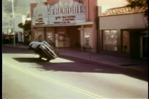 Stunt driver riding in car on two wheels Stock Footage 25207527