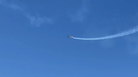 Stunt Plane Performing Aerobatics with Smoke Trail over Gold Coast Stock Footage 345103232