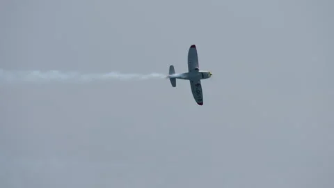 Stunt plane turning in the sky with smoke trail Stock Footage 316498066