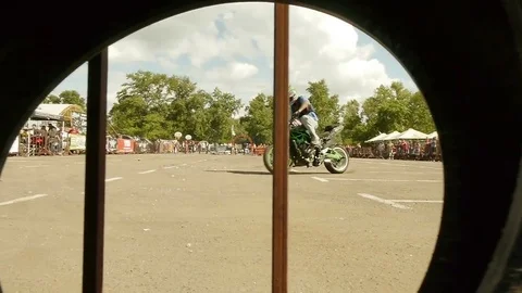 Stunt Riding View Through the Wheel Stock Footage 78339944