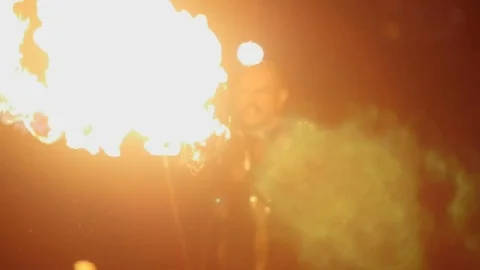The stuntman releases a circle from the flamethrower. Action in slowmotion Stock Footage